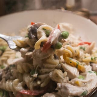 Close-up of creamy Chicken Pasta ala King on a fork.