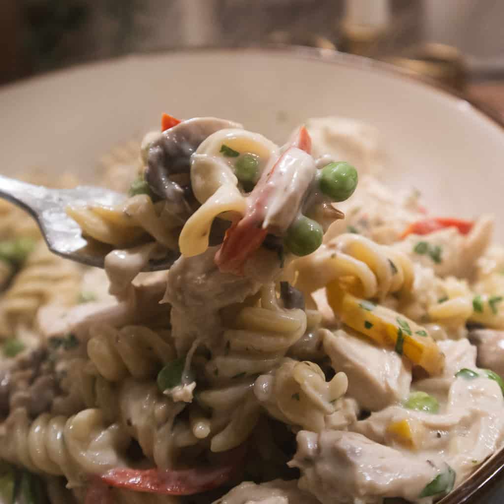 Close-up of creamy Chicken Pasta ala King on a fork.