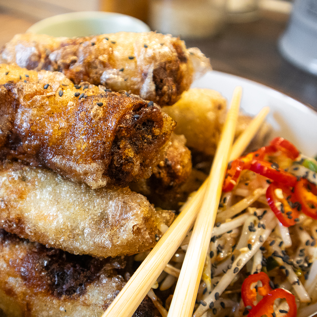 Crispy Fried Vietnamese Roll served with spicy beansprouts, served with chopsticks.